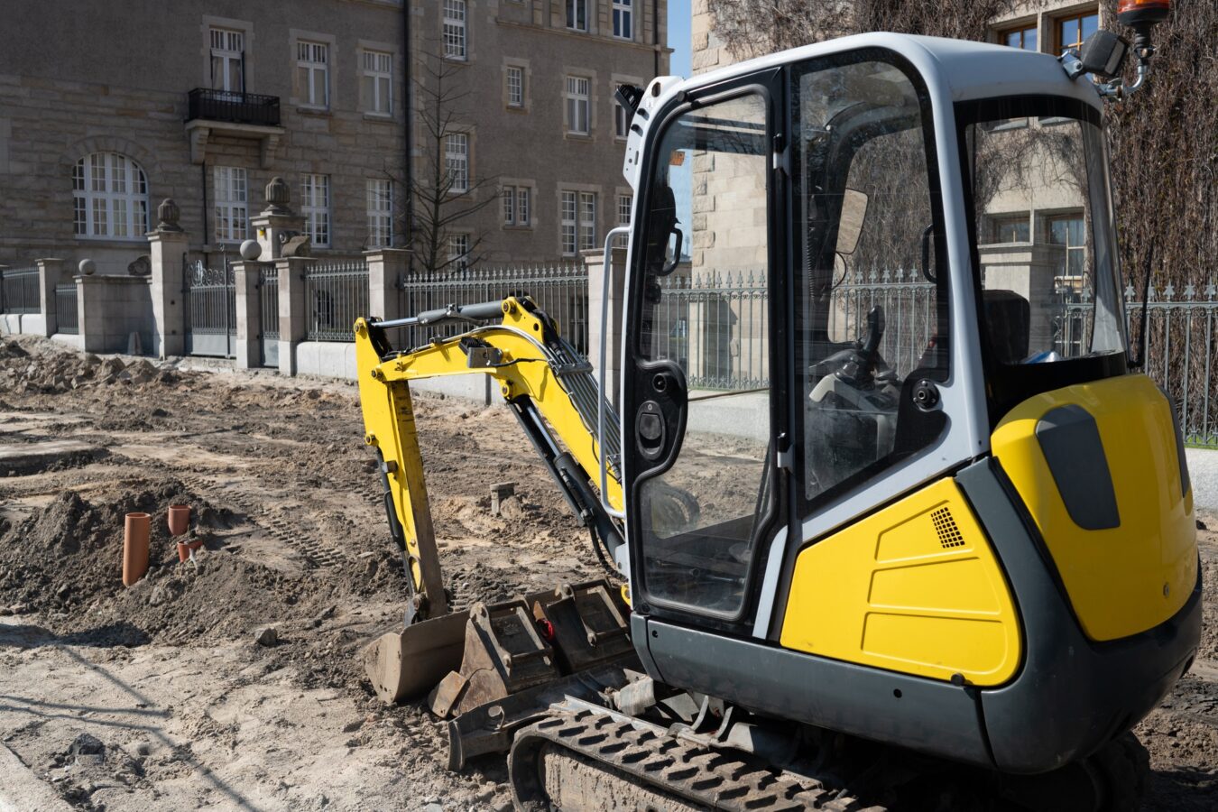 Construction Excavator Performs Road Repair Work